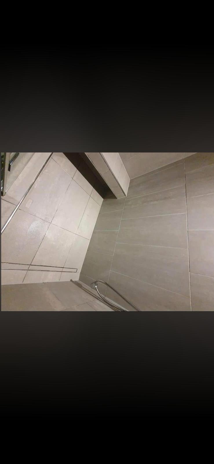 Spotless bathroom tiles after cleaning