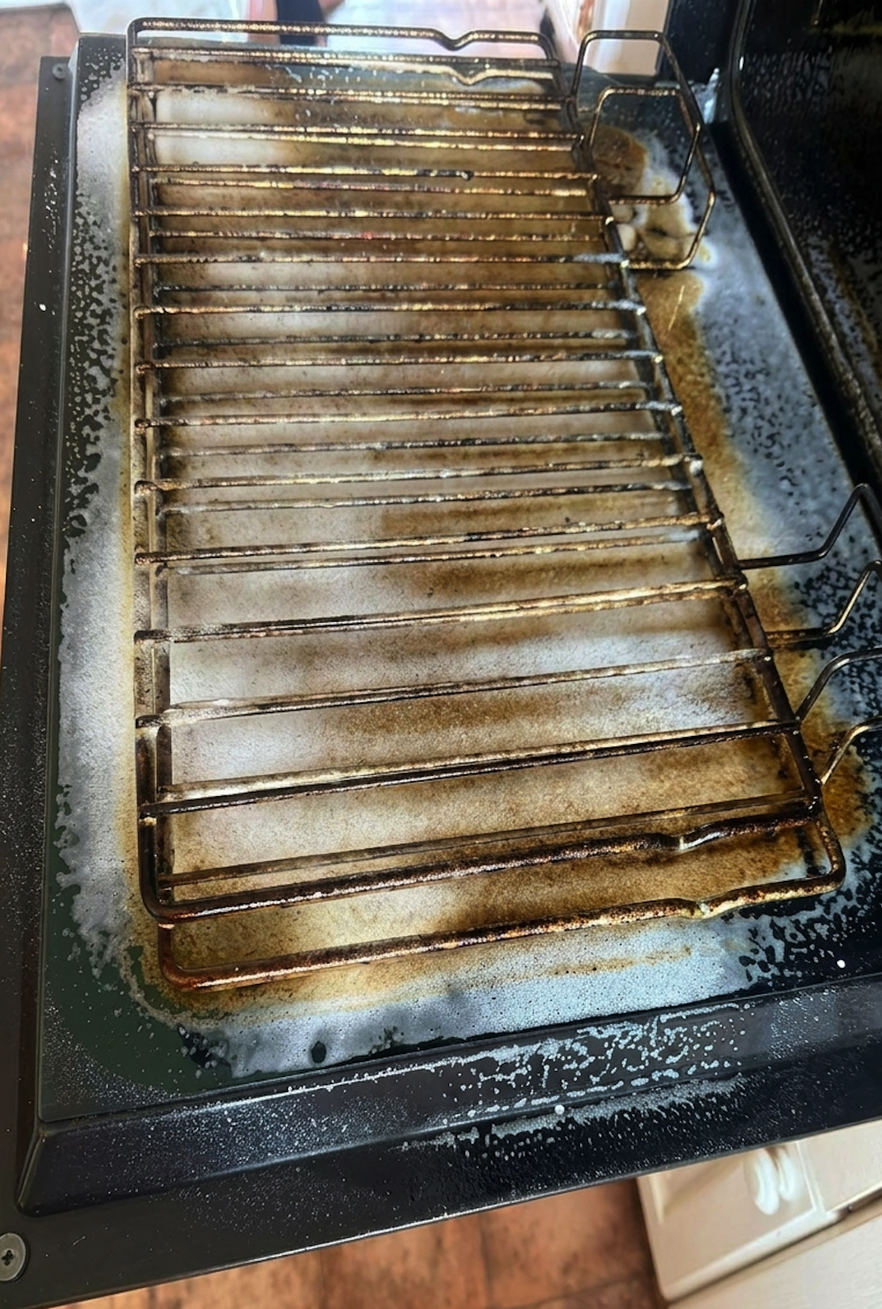 Oven interior before cleaning — heavy grease build-up